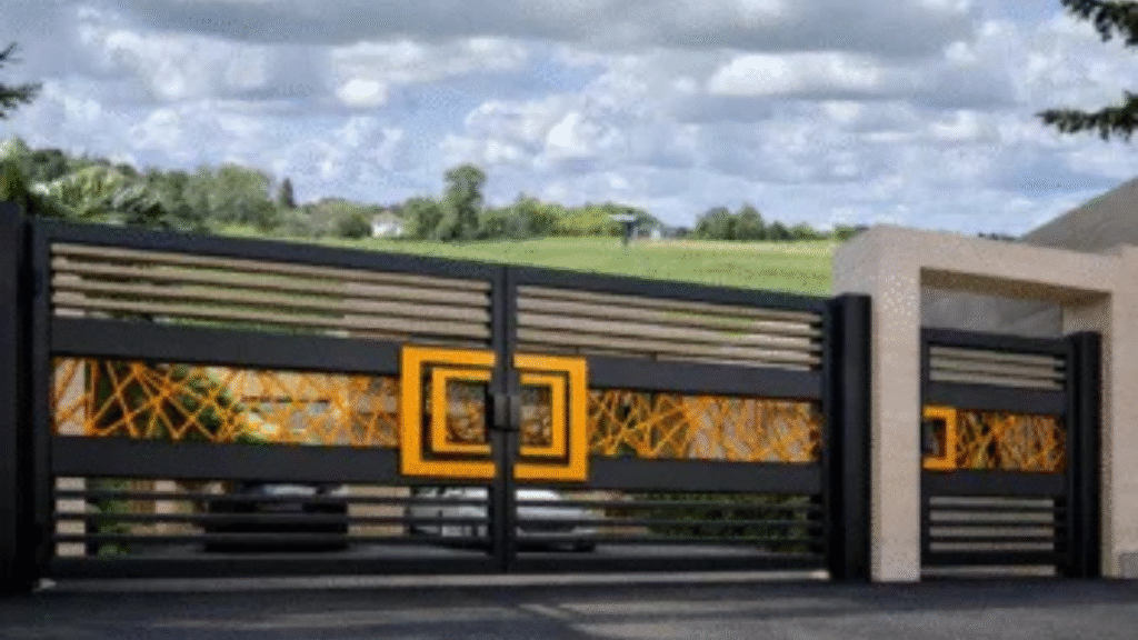 Modern black and gold metal gate with geometric design.